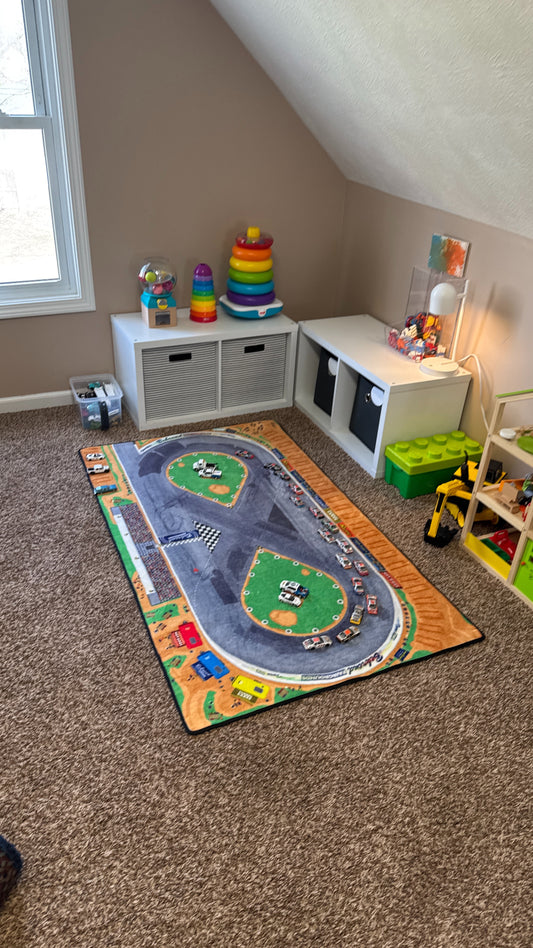 Fairgrounds racetrack rug with toys in background